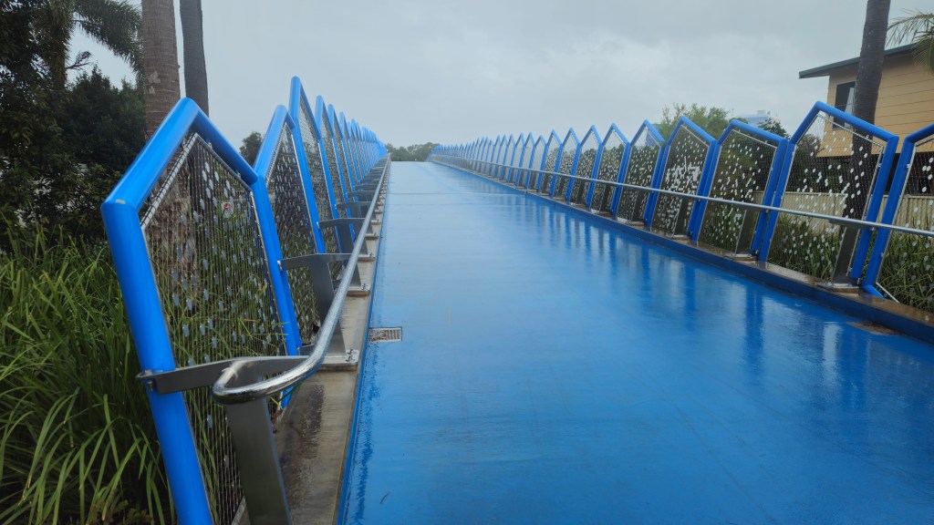 “Pedestrian bridge on the Gold Coast in rainy weather”